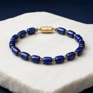 Deep blue lapis lazuli bracelet with gold-toned detail