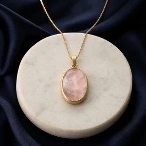 Rose quartz pendant on a restrained warm background